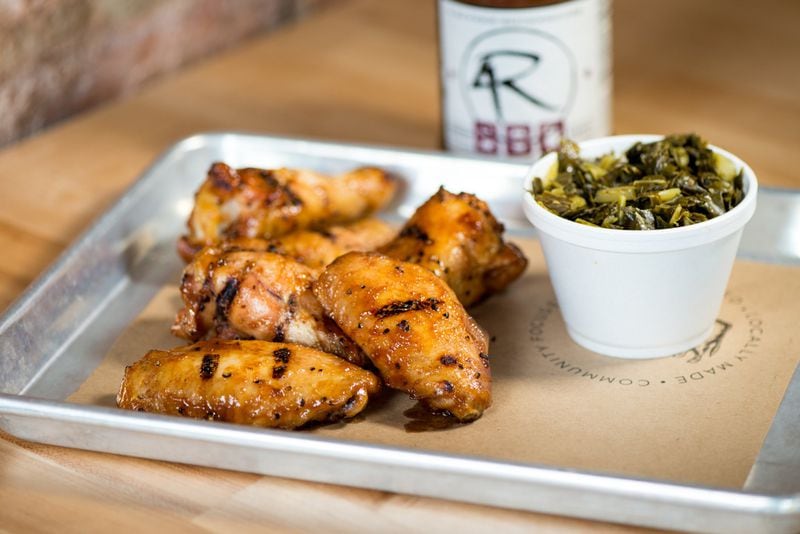  4 Rivers Smokehouse Chicken Wings with signature sauce and side of collards. Photo credit- Mia Yakel.