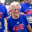 Betty Lindberg, 98, crosses the finish line of the 54th running of the Atlanta Journal-Constitution Peachtree Road Race in Atlanta on Tuesday, July 4, 2023.  Lindberg set the 5K World record in 2022 in the 95-99 age group.