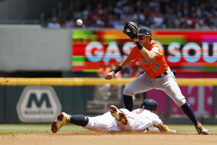 Astros’ second base Mauricio Dubón (14)  can not tag Braves right fielder Ronald Acuña (13) during the first inning at Truist Park on Sunday, April 23, 2023, in Atlanta. 
 Miguel Martinez / miguel.martinezjimenez@ajc.com 