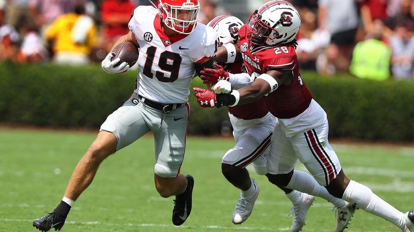 Georgia tight end Brock Bowers makes a first-down reception against South Carolina. Bowers caught five passes and scored three touchdowns in the game. (Curtis Compton / Curtis Compton@ajc.com)