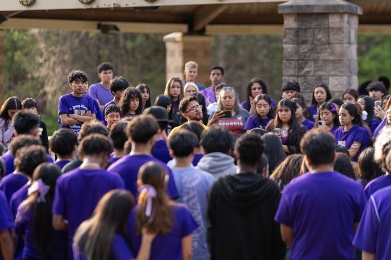 Mourners stand and listen to a speech during a memorial and candlelight vigil on March 16, 2024, at Graves Park in Norcross for Guillermo Aguas-Bahena, one of five Lakeside High School students killed in vehicle crashes this school year. (Jason Allen for The Atlanta Journal-Constitution) 