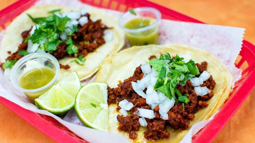 These chorizo tacos at Supermercado Chicago are dressed up with a few items from the salsa bar. CONTRIBUTED BY HENRI HOLLIS