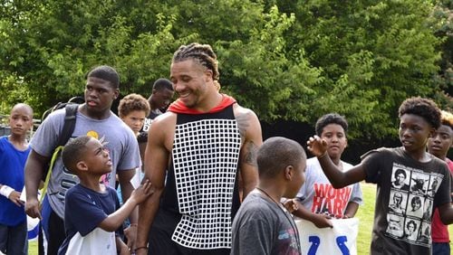 Edwin Jackson interacts with youths. Jackson, a native Atlantan, played for the Indianapolis Colts. He also started a foundation, the Edwin Jackson 53 Foundation. (Family photo)