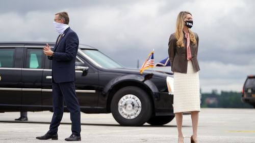 FILE -- Rep. Doug Collins (R-Ga.) and Sen. Kelly Loeffler (R-Ga.) wait to greet President Donald Trump at the airport in Atlanta on Sept. 25, 2020. Collins is running in a special election against Loeffler, who was appointed to her seat; but the Democrat in that race, Raphael Warnock, is now leading in a poll. (Anna Moneymaker/The New York Times)