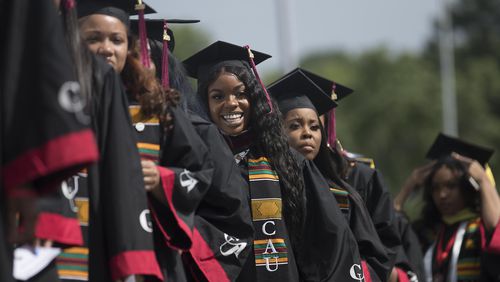 Proud graduates line up on stage before receiving their degree during Clark Atlanta University's 30th annual commencement ceremony at Panther Stadium in Atlanta, Monday, May 20, 2019. Its enrollment is about 4,000 students, the largest of any historically black college and university in Atlanta. (Alyssa Pointer/alyssa.pointer@ajc.com)