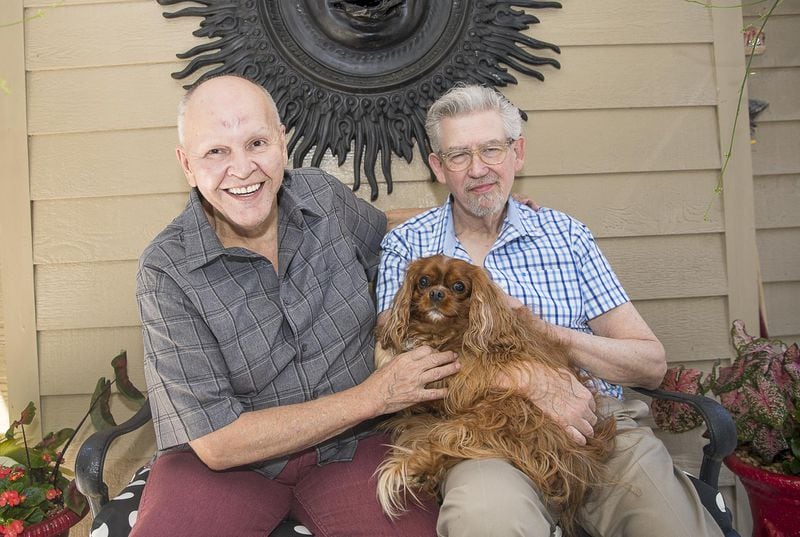 Partners Charles Dillard, left, and Fred Wise sit for a photo with their dog Rusty at their residence in Austell. Wise has been involved in Dillard’s career for much of the past several decades.