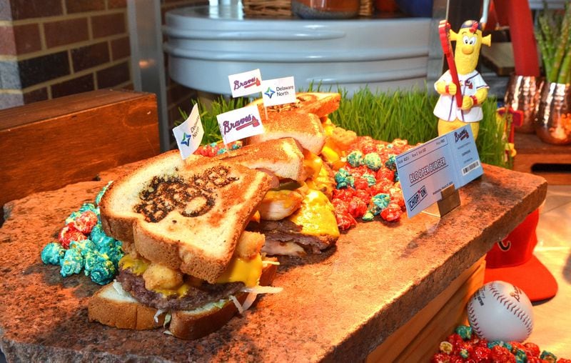 BLOOPER Burger (Section 113). Braves Mascot BLOOPER kept busy this offseason in the ballpark kitchen, designing his favorite new snack at SunTrust Park. This giant sandwich features a bit of everything, including 4 cheeseburger patties, a footlong hot dog, and chicken tenders, all with lettuce, tomato, onion, and jalapenos, covered in cheese sauce and nestled inside cross cut Texas toast. Served with Braves Country candied popcorn. $26.00