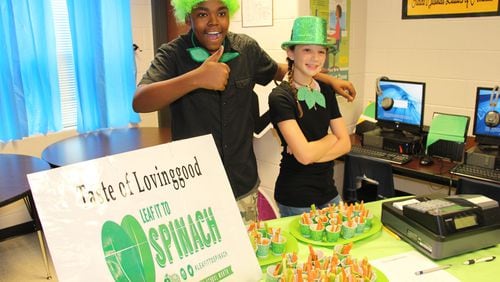 Students from Lovinggood Middle in west Cobb County hosted a spinach tasting after growing the green in the school garden. The project is supported by four disciplines working together to give students a feel for real-world work.