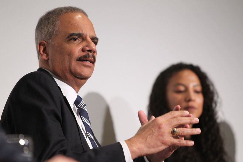 Former Attorney General Eric Holder forms an argument while fellow panelist Elizabeth Hinton listens Wednesday at the Carter Library. (Henry Taylor / henry.taylor@ajc.com)