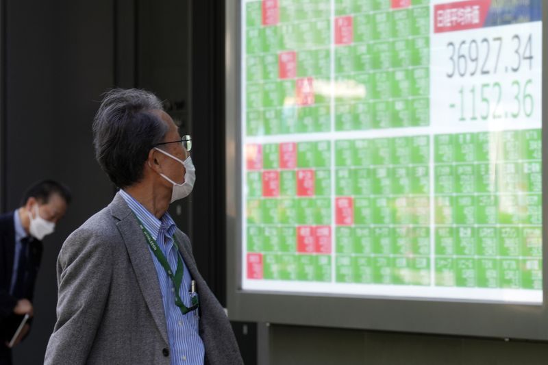 A person looks at an electronic stock board showing Japan's Nikkei 225 index at a securities firm Friday, April 19, 2024, in Tokyo. (AP Photo/Eugene Hoshiko)