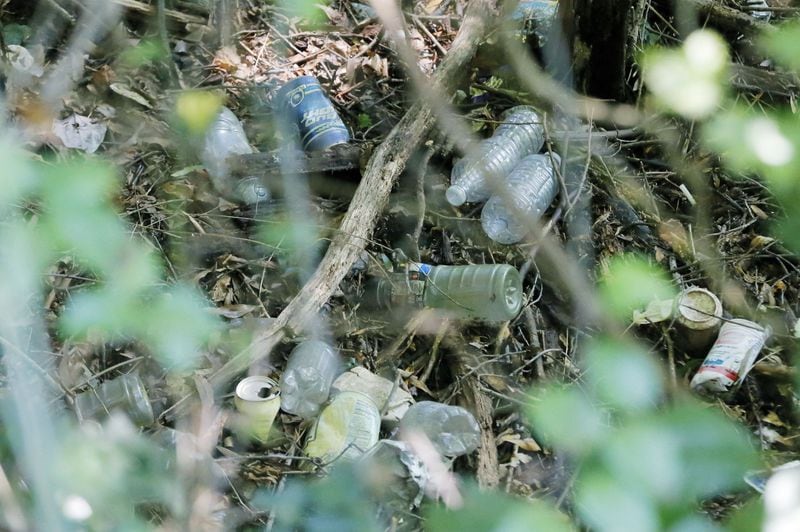 Discarded rubbish, like these bottles and cans found in a culvert, can contain enough water for mosquitoes to breed. After stretches of heavy rains, mosquitoes tend to multiply, and this year testing is showing an unusually high number of mosquitoes testing positive for West Nile virus. BOB ANDRES / BANDRES@AJC.COM