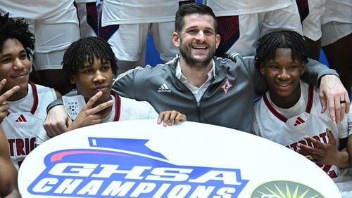 Sandy Creek's head coach Jon-Michael Nickerson celebrates with players after Sandy Creek beat Johnson-Savannah during GHSA Basketball Class 3A Boy’s State Championship game at the Macon Centreplex, Friday, Mar. 8, 2024, in Macon. Sandy Creek won 74-49 over Johnson-Savannah. (Hyosub Shin / Hyosub.Shin@ajc.com)