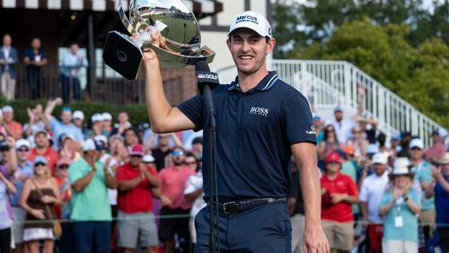 Patrick Cantlay hoists the FedEx Cup trophy after winning the PGA Tour Championship Sunday, Sept. 5, 2021, at East Lake Golf Club in Atlanta. (Ben Gray/For the AJC)