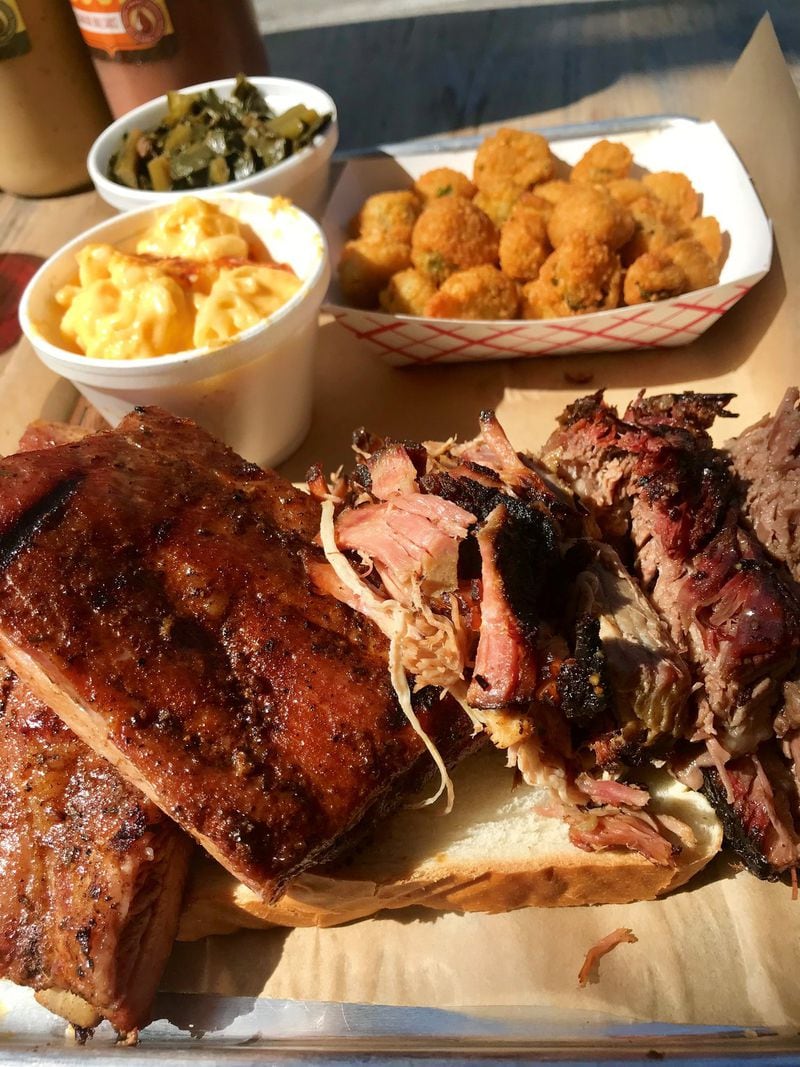 When visiting Southern Soul Barbeque, go all-out with an order of the Southern Soul Sampler. Pictured here is a plate with pulled pork, ribs, brisket fried okra, mac and cheese and collards. LIGAYA FIGUERAS / LFIGUERAS@AJC.COM