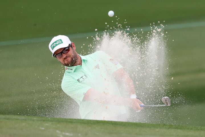 April 10, 2021, Augusta: Corey Conners hits out of the bunker on the second hole during the third round of the Masters at Augusta National Golf Club on Saturday, April 10, 2021, in Augusta. Curtis Compton/ccompton@ajc.com