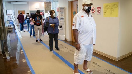Emanual Frazier (R) stands in line to vote at The Wolf Creek Library in Atlanta Saturday, August 1, 2020.  STEVE SCHAEFER / SPECIAL TO THE AJC