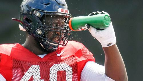 Mississippi's Josiah Coatney cools off during football practice in Oxford, Miss., Wednesday, Aug. 7, 2019. The defensive tackle from Douglasville, Ga., is looking to impress NFL scouts at the 2020 Senior Bowl.