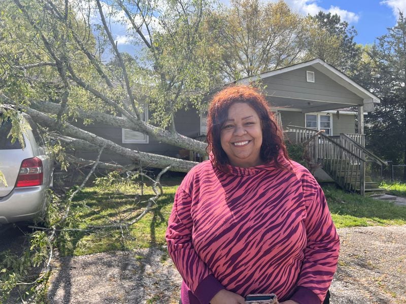 Denise Johnson stands outside her Conyers-area home after a large tree fell amid strong storms that spurred a tornado Tuesday just before midnight. 