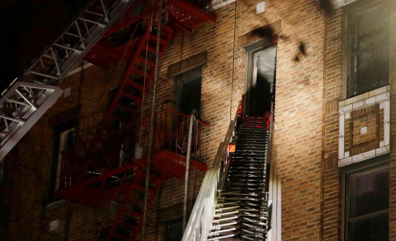 Firefighters respond to a deadly fire Thursday, Dec. 28, 2017, in the Bronx borough of New York. The New York City mayor's press secretary says several people have died in the blaze on a frigid night, and several more have been injured.