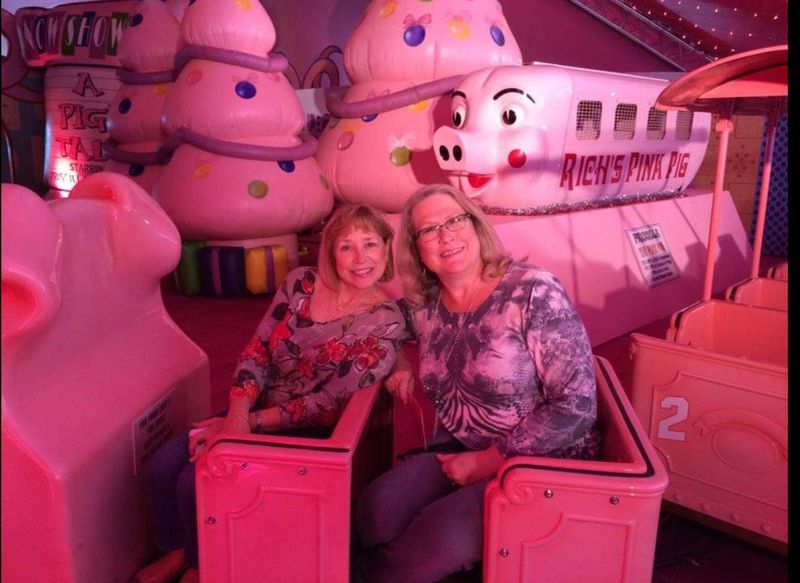 For their 60th birthday celebrations, Shelley Hamann of Peachtree City (left) invited her best friend Elaine Leker to a tour of Atlanta landmarks that included the Pink Pig. (Courtesy of Shelley Hamann)