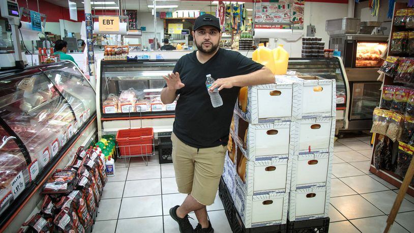 Carlos Vazquez stands in his family’s store, the Mercado Real De La Villa, located near the Marietta flea market, which the city of Marietta is preparing to spend $5.8 million to buy and demolish. STEVE SCHAEFER / SPECIAL TO THE AJC