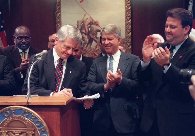 Then-Lt. Gov. Pierre Howard, center, is flanked by Gov. Zell Miller and state Sen. Mark Taylor in 1997 at the Georgia Capitol, where he served 26 years in office, beginning as a state senator. He's spent the decades that followed pursuing a new quest, trying to photograph each of the 172 species of butterflies that exist in Georgia. (Kimberly Smith/AJC staff)