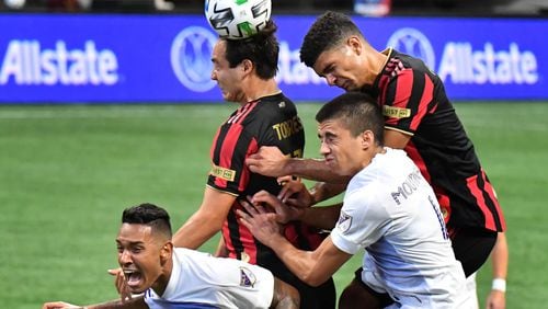 August 29, 2020 Atlanta - Atlanta United forward Erick Torres (left) and Atlanta United defender Miles Robinson battle for the ball with Orlando City defender Antonio Carlos (left) and Orlando City defender Joao Moutinho during the second half in a MLS soccer match at Mercedes-Benz Stadium in Atlanta on Saturday, August 29, 2020. Orlando City won 3-1 over the Atlanta United. (Hyosub Shin / Hyosub.Shin@ajc.com)