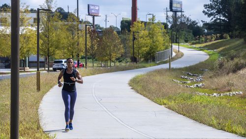 Southwest Atlanta resident Ericka Lallis exercises on the Southside trial of the Atlanta BeltLine in the Pittsburgh community. Atlanta received a $16.4 million federal grant this week for more Beltline construction. (Alyssa Pointer/ Alyssa.Pointer@ajc.com)