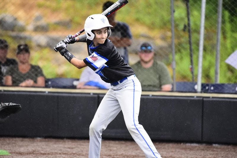 Gabi Yulo, a 14-year-old high school freshman, is shown at a baseball tournament. “I’ve never been told you have to make a switch (to softball), but I’m asked: Are you going to make the switch?” said Gabi, who lives in Tucker. CONTRIBUTED