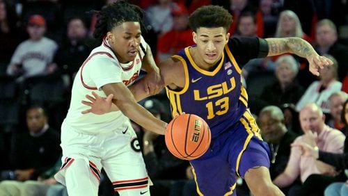 Georgia guard Silas Demary Jr. (left) and LSU forward Jalen Reed (13) fight for a loose ball during the first half of an NCAA college basketball game at Stegeman Coliseum, Wednesday, January 24, 2024, in Athens. (Hyosub Shin / Hyosub.Shin@ajc.com)