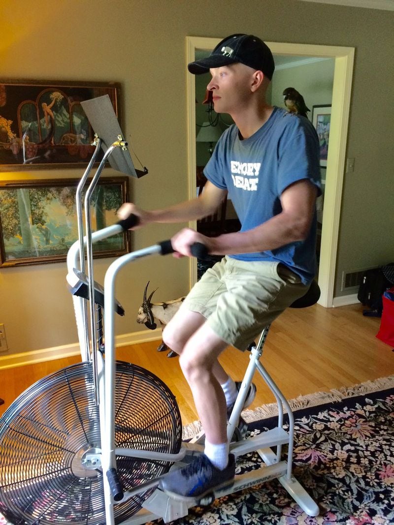 Michael Torpy on his recumbent bike with his pet parrot, Maya, on his shoulder.