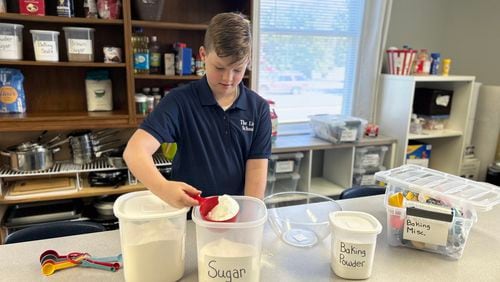 Student Ben Herbert measures ingredients for a cake as part of The Link School's life skills class.