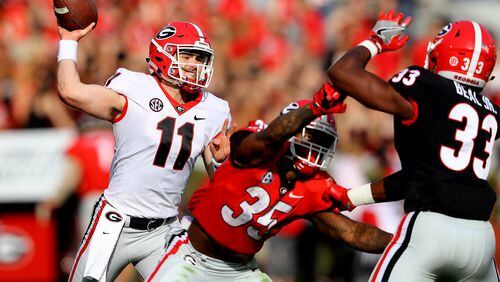 Jake Fromm gets off a pass while tailback Brian Herrien blocks in the annual G-Day spring intrasquad football game. More than 82,000 fans attended the game Saturday at Sanford Stadium in Athens. (Curtis Compton/ccompton@ajc.com)