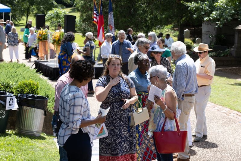 People gather together and talk after the Historic Oakland Foundation ceremony for the newly restored African American Burial Grounds at Oakland Cemetery on Friday, June 10, 2022. (Steve Schaefer / steve.schaefer@ajc.com)