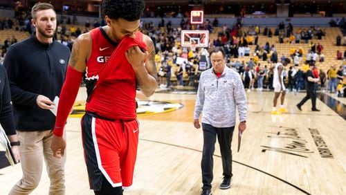 Georgia's Braelen Bridges wipes his face as he walks off the court and coach Tom Crean (right) follows after losing 79-69 to Missouri in an NCAA college basketball game Saturday, March 5, 2022, in Columbia, Mo.  (AP Photo/L.G. Patterson)