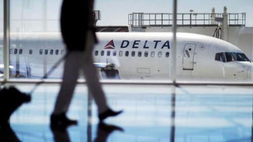 In this Thursday, Oct. 13, 2016, photo, a Delta Air Lines jet sits at a gate at Hartsfield-Jackson Atlanta International Airport in Atlanta. (AP Photo/David Goldman)