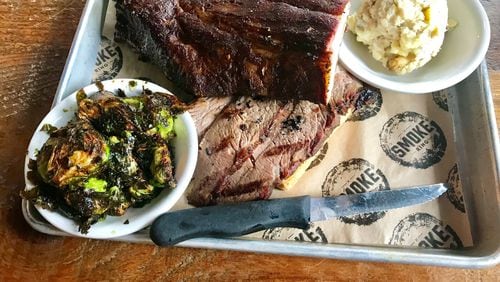 Smoke Ring offers various barbecue plates. Pictured is a plate with a half-rack of baby back ribs (top) and sliced brisket, and side dishes of potato salad and barbecue Brussels sprouts. LIGAYA FIGUERAS / LFIGUERAS@AJC.COM