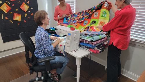Members of the East Cobb Quilters' Guild produce quilts, placements and pillowcases for a variety of nonprofits. Pictured left to right are members Meridith Mask, Judy Weathers and Linda Bailey .