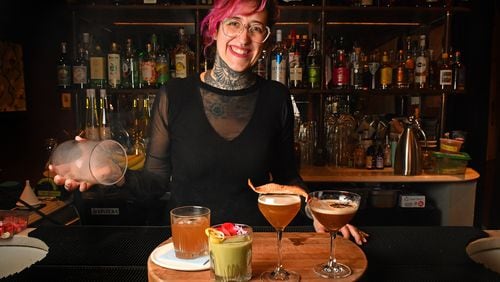 Flemming Love, mixologist at Southern Belle and Georgia Boy, performs the final stage, a smoke dome, on a nonalcoholic cocktail called Modern Yesterdays (left); also shown: At Dusk or Dawn, Southern Sentiments, and Dear Diary (far right). (Styling by Flemming Love / Chris Hunt for the AJC)
