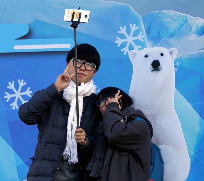 Taking a selfie near a wild animal is never a good idea unless the wild animal is really just a poster. (AP file photo)