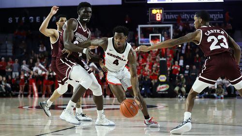 Georgia guard Tyree Crump (4) dribbles past opponents during a game between Georgia and Mississippi State at Stegeman Coliseum in Athens, Ga., on Wednesday, Feb. 20, 2019. (Photo by Lauren Tolbert/UGA)