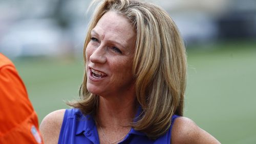 In this Saturday, July 29, 2017, photograph, sports anouncer Beth Mowins chats with a reporter while watching the Denver Broncos run through drills at an NFL football training camp  in Englewood, Colo. While Mowins is focused on football, she will become the first woman since 1987 to be the lead announcer on a nationally televised, regular season NFL game. (AP Photo/David Zalubowski)