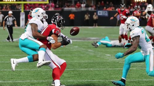 October 15, 2017 Atlanta: Miami Dolphins cornerback Cordrea Tankersley hits Atlanta Falcons tight end Austin Hooper knocking the ball loose for a interception by safety Reshad Jones (right) on a pass from Matt Ryan during the final minute of the game to beat the Falcons 20-17 in a NFL football game on Sunday, October 15, 2017, in Atlanta.   Curtis Compton/ccompton@ajc.com