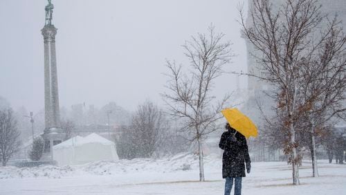 Sarah Wilson walks down the hill along Kellogg Avenue in St. Paul,. Minn., with an umbrella to shield the wind and snow last Monday. A blizzard warning was in effect for much of south central and southeastern Minnesota last week.