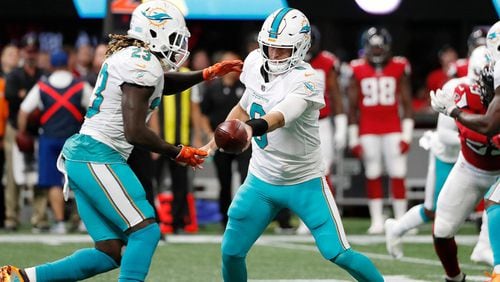 Miami Dolphins quarterback Jay Cutler (6) hands the ball off to Miami Dolphins running back Jay Ajayi (23) against the Atlanta FalconsH during the first half of an NFL football game, Sunday, Oct. 15, 2017, in Atlanta. (AP Photo/ David Goldman))