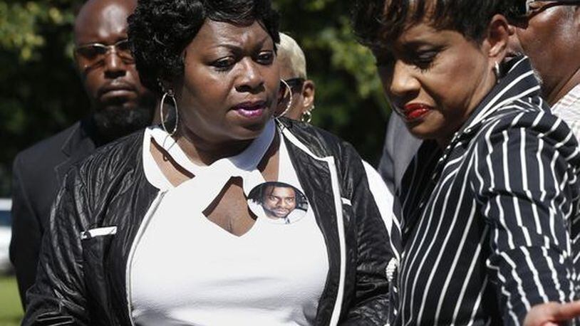 Judge Glenda Hatchett (right) escorts Valerie Castile, the mother of Philando Castile, off the platform after a news conference on the State Capitol grounds Tuesday in St. Paul, Minn. Hatchett, known for the TV show “Judge Hatchett” and her time as chief judge of the Juvenile Court of Fulton County in Atlanta, is representing the Castile family in the shooting death by police of Philando Castile last week in Falcon Heights, Minn., after a traffic stop. JIM MONE / AP