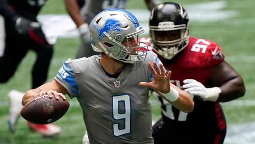 Detroit Lions quarterback Matthew Stafford (9) works in the pocket under pressure by Falcons defensive tackle Grady Jarrett (97) during the first half Sunday, Oct. 25, 2020, at Mercedes-Benz Stadium in Atlanta. (John Bazemore/AP)