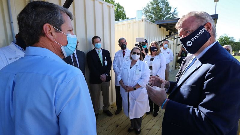 Gov. Brian Kemp (left) tours the temporary medical pod that has been placed at the North Campus of Phoebe Putney Health System with their CEO Scott Steiner (right) on Tuesday, May 5, 2020, in Albany. The pod is scheduled to begin operations on Wednesday, May 6, housing 24 beds to treat non-critical COVID-19 patients. (CURTIS COMPTON / ccompton@ajc.com)
