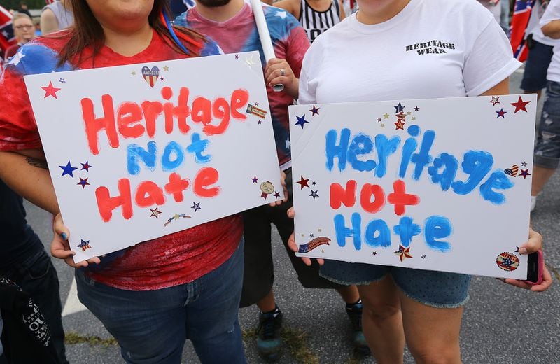 080215 STONE MOUNTAIN: Brittany Underwood (left) and Charlotte Holland hold signs during a pro-Confederate flag rally at Stone Mountain Park on Saturday, August 1, 2015, in Stone Mountain. Curtis Compton / ccompton@ajc.com