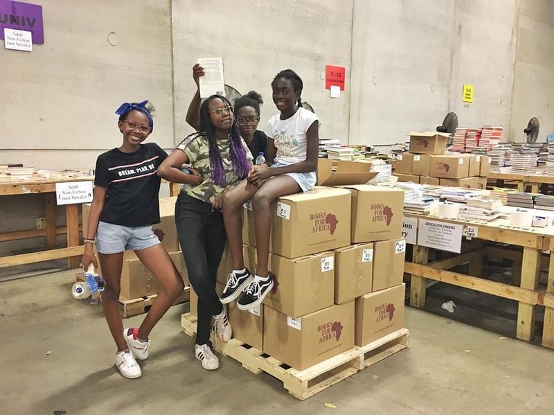 The Uwhubetine and Asase sisters began volunteering at Books for Africa shortly after forming their nonprofit Child2Child Book Foundation. They partner with Books for Africa and have shipped 60,000 books to Nigera and Ghana. Pictured from left are: Amirrah Uwhubetine, Azzarrée Uwhubetine, Sedinam Asase and Eline Asase. Photo courtesy of Child2Child Book Foundation